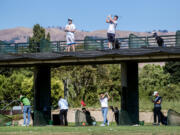 Golfers practice at the double-decker driving range July 13 at the San Jose Municipal Golf Course in San Jose, Calif.