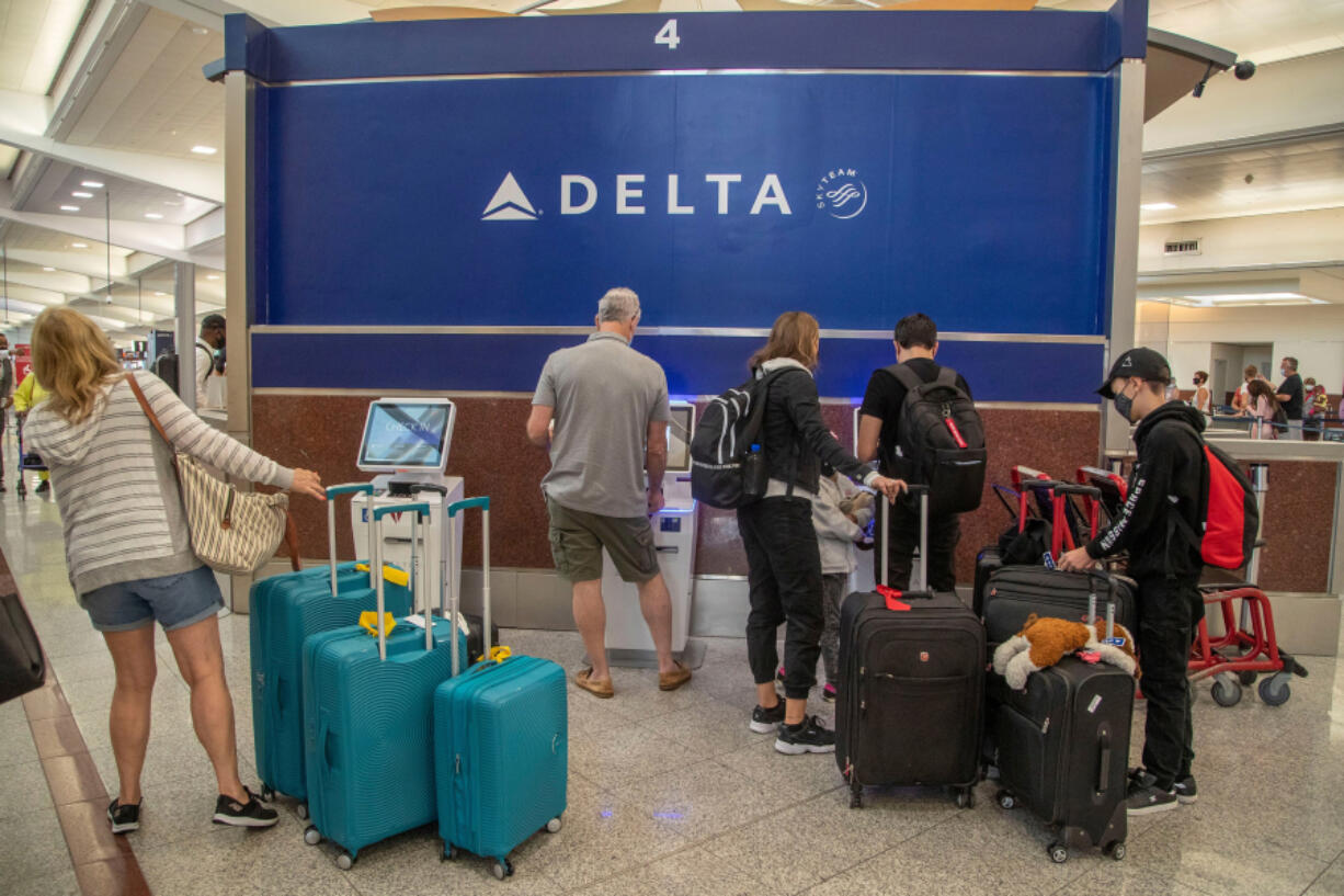 Delta Air Lines patrons check-in at the electric kiosk during an early morning at Hartsfield-Jackson Atlanta International Airport in June 2021 in Atlanta.