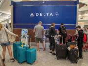 Delta Air Lines patrons check-in at the electric kiosk during an early morning at Hartsfield-Jackson Atlanta International Airport in June 2021 in Atlanta.