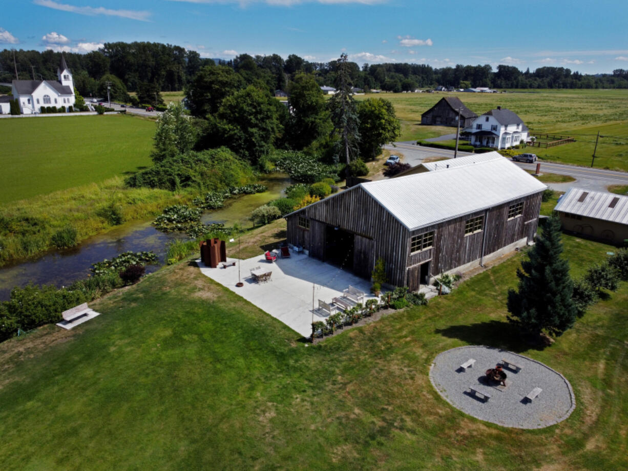 The Saltbox Barn, seen from the air, is an events business, Wednesday, July 26, 2023, in Mount Vernon, Washington. The married couple who owns it risks going out of business if a code change in Skagit County goes through, prohibiting wedding venues from operating in the county where it is zoned for only agriculture on farmlands.