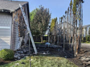 An arborvitae fire Sunday afternoon in Orchards that spread to nearby houses. Ashes from the fire also sparked small bark dust fires throughout the neighborhood.