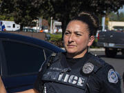 Officer Andrea Mendoza of the Vancouver Police Department escorts a suspected shoplifter into a patrol car Oct. 12, 2022, at the Fred Meyer store in Cascade Park. Mendoza is facing fourth-degree assault, a gross misdemeanor, after she was captured on video threatening to use her Taser on the genitals of a suspected shoplifter in May.