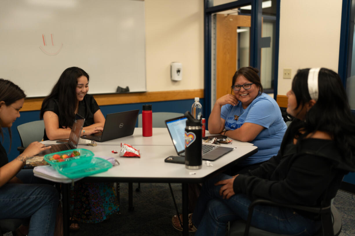 Ally Gee and Shannen Jones sit with other students during an All Our Kin Collective class.