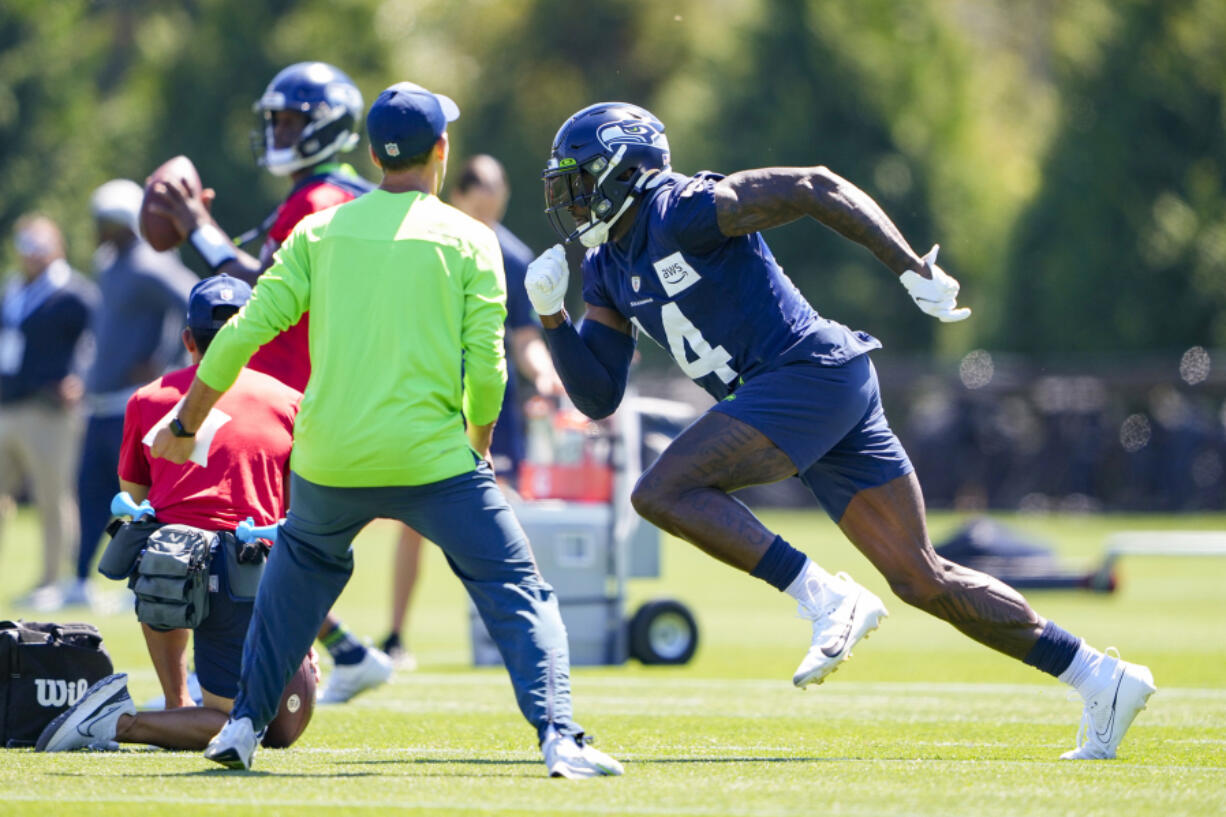 Seattle Seahawks wide receiver DK Metcalf (14) runs during the NFL football team's training camp, Thursday, Aug. 3, 2023, in Renton, Wash.