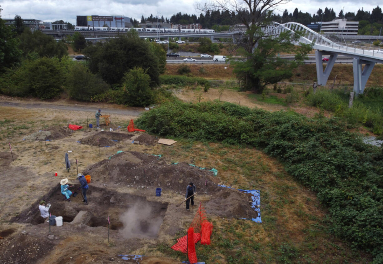 With light-rail and Interstate 5 as a backdrop, an archeological dig is seen from the air on July 25, 2023, near Northgate in Seattle. Artifacts recovered are from the former site of the Green Lake Gardens Company run by the Kumasaka family from the early 20th century until the 1940s. The site was an active home and farm for the family, and also housed a community center for Japanese residents until President Franklin Roosevelt signed Executive Order 9066, forcing Japanese Americans from the West Coast into incarceration camps.