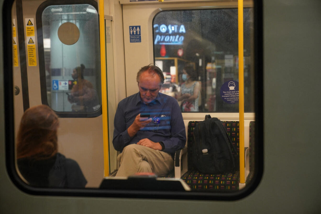 Commuters on a Circle Line tube train at Westminster Underground station on July 19, 2021, in London.