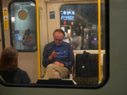 Commuters on a Circle Line tube train at Westminster Underground station on July 19, 2021, in London.