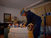 Amy Wiedeman gets her 12-year-old son Luke Schiller ready for bed at their home in Centennial, Colorado, on Jan. 31, 2023. Colorado's Medicaid agency is asking for more money for people who provide home care services for people like Luke, who has cerebral palsy and other illnesses that require around-the-clock care. Wiedeman said they've never been able to hire all the help Luke qualifies for, so she and her ex-husband take "night shifts" making sure Luke doesn't choke or have a seizure.