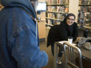 Jamie Spinelli chats in 2018 with a resident at Vancouver Community Library. Spinelli said patience and kindness toward those experiencing homelessness is paramount.