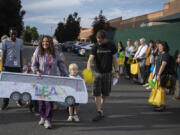 Students and teachers from Educational Opportunities for Children and Families greet participants in the Legislator Education & Action Project as they make a brief stop on their bus tour Friday morning. State dignitaries joined regional early education leaders for a rally in support of their services. As Clark County and greater Southwest Washington struggles to provide services for a growing young student population, a proposed House budget could lead to another massive cut.