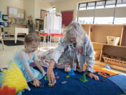 Preschooler Kymber McIntyre, 4, left, enjoys some playtime with Kim Frosh, Child Care Aware Specialist with Educational Service District 112, as she takes a tour of the Educational Opportunities for Children and Families' location in northeast Vancouver in August 2023.