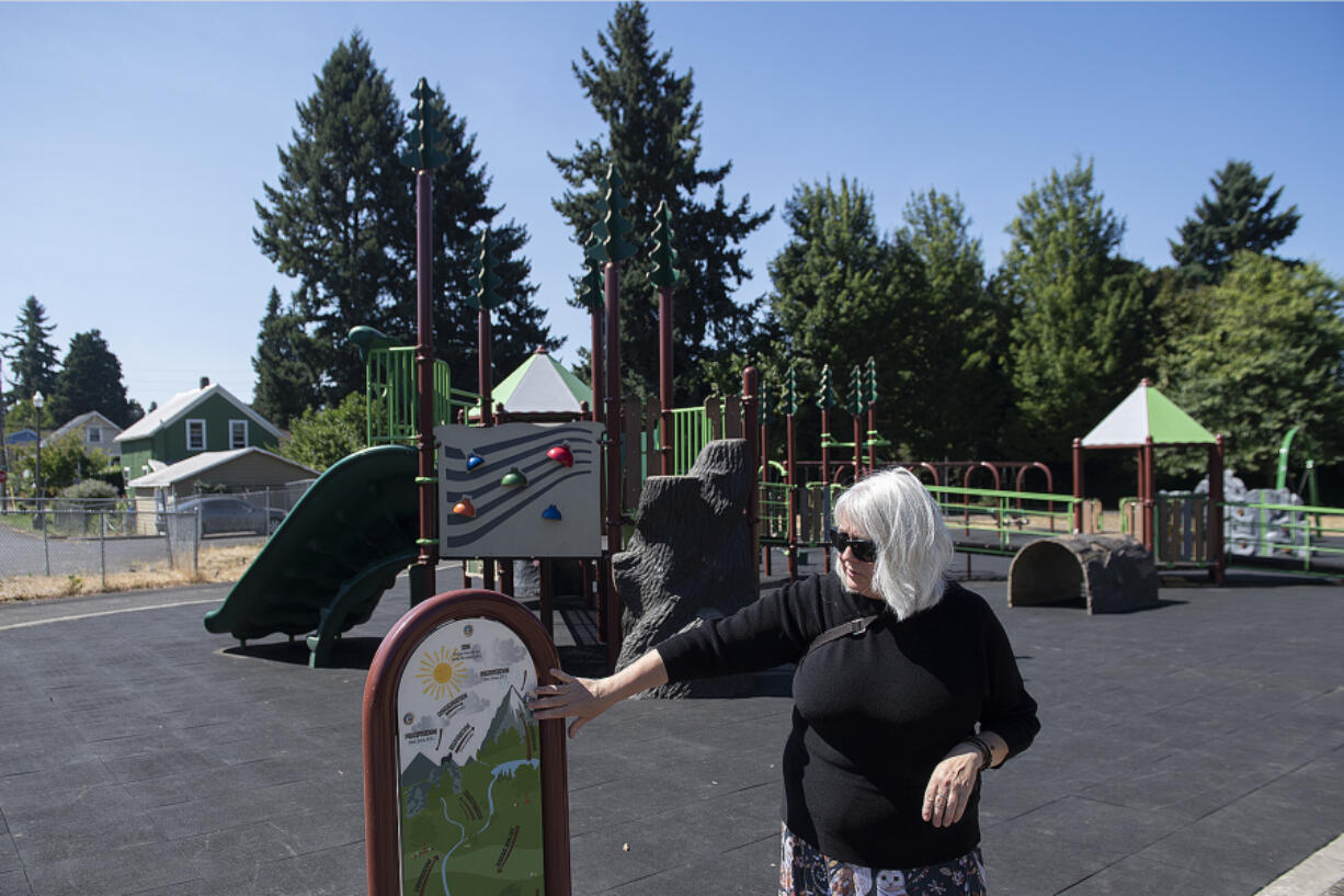 Playground designer Jane Tesner-Kleiner looks over a sign at the Hough Elementary School playground Wednesday morning. Bond measures in recent years have allowed Vancouver Public Schools and Evergreen Public Schools to totally revamp elementary school playgrounds for both accessibility and diversity of options for play.