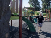 Playground designer Jane Tesner-Kleiner looks over the playground at Hough Elementary School on Wednesday morning. Bond measures in recent years have allowedVancouver Public Schools and Evergreen Public Schools to totally revamp elementary school playgrounds for both accessibility and diversity of options for play.