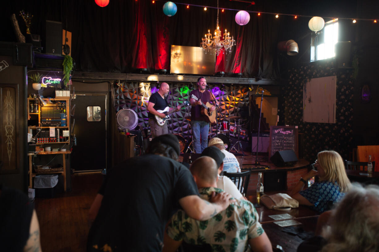 Chris Covin of Vancouver plays two songs at Brickhouse's open mic with backup by event host Duchebag, at left.