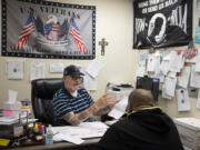 County service officer Mark Kriesen, facing, works with a client at Clark County Veterans Assistance in downtown Vancouver.