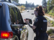 Detective Bethany Lau of the Clark County Sheriff's Office talks to a driver she pulled over for speeding in Salmon Creek. The driver was going 46 mph in a 35 mph zone and was let off with a verbal warning.