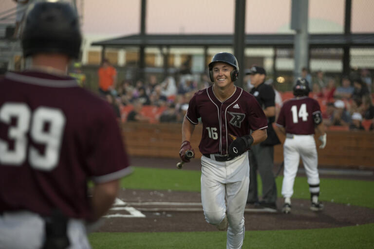 Raptors' Jack Salmon heads to the dugout after scoring a run to tie up the game 5-5 in the bottom of the sixth inning against Walla Walla at the Ridgefield Outdoor Recreation Complex on Thursday, Aug. 3, 2023.