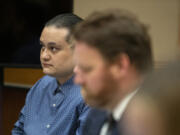 Defendant Abran Raya Leon, left, sits with his legal team Aug. 8 before opening statements in his trial in Clark County Superior Court.