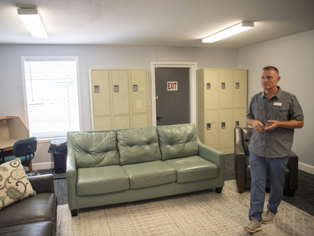 Family Promise of Clark County Executive Director Shane Scalf showcases a living room at the new location at River City Church in Vancouver. The space will offer a stable environment for families to do laundry, cook and relax. The nonprofit moved in order to have a more central location for its clientele to access main transit lines and community services.