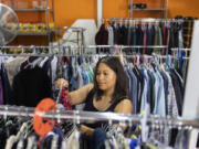 Leticia Amezcua looks for clothes Wednesday at The Giving Closet. Amezcua said she's been shopping for her family here for 15 years. Founder Denise Currie says the free community store could be forced to close in as little as five months if it does not find new funding sources.