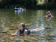 Vika Eykhman, 13, of Vancouver escapes the heat in the cool waters of the Washougal River at the Sandy Swimming Hole on Monday afternoon. Eykhman was one of dozens of locals that sought out the popular spot as a refuge from the high summer temperatures. "It's cold. I just usually get right in," she said.