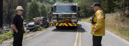 Battalion Chief Jason Leavitt, left, and Division Chief Ben Peeler take a moment to check in at the Jenny Creek Fire near La Center on Thursday afternoon, Aug. 17, 2023.