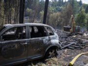 Cleanup begins on the Jenny Creek Fire site near La Center on Thursday afternoon, Aug. 17, 2023. The fire started at a residence and spread to wooded areas.