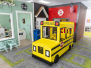 A toy school bus sits in the middle of a mock town Friday, Aug. 18, 2023, at City Play for Kids in Vancouver.