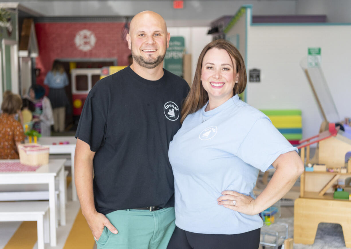 Owners Greg, left, and Laura Silva stand for a portrait at their new east Vancouver business, City Play for Kids.