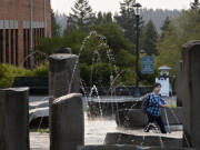 A student strolls through campus on the first day of classes at Washington State University Vancouver on Monday morning.