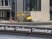 A small excavator sits in front of Ruth Bader Ginsburg Elementary School -- Vancouver Public Schools' newest elementary school -- while construction continues Friday in Vancouver.