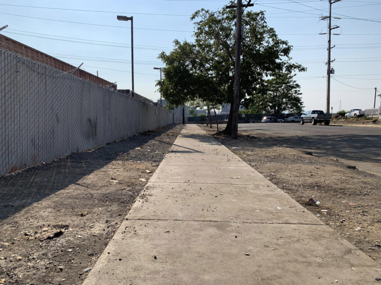 A sidewalk near the Share House Men's Shelter in downtown Vancouver was empty Thursday afternoon after being packed with tents.