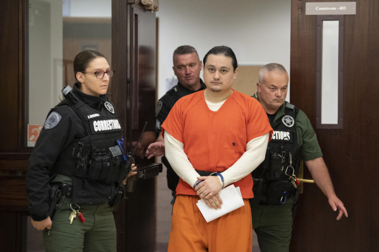 Abran Raya Leon, center, the getaway driver in the fatal shooting of Clark County sheriff's Sgt. Jeremy Brown, is escorted out of the courtroom following his sentencing Thursday at the Clark County Courthouse. A judge sentenced him to 27 years and one month in prison, the high end of his sentencing range.