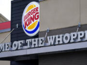 A "Home of the Whopper" sign welcomes customers outside the Burger King fast food restaurant, Monday, Feb. 1, 2021, in Epping, N.H.