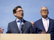 Washington Attorney General Bob Ferguson speaks as Washington Gov. Jay Inslee, right, looks on before the signing of several bills aimed at protecting reproductive health and gender-affirming care on April 27, 2023, at the University of Washington's Hans Rosling Center for Population Health in Seattle. Attorney General Ferguson launched an exploratory campaign for governor on Tuesday, May 2, 2023, one day after incumbent Jay Inslee announced he would not run again.