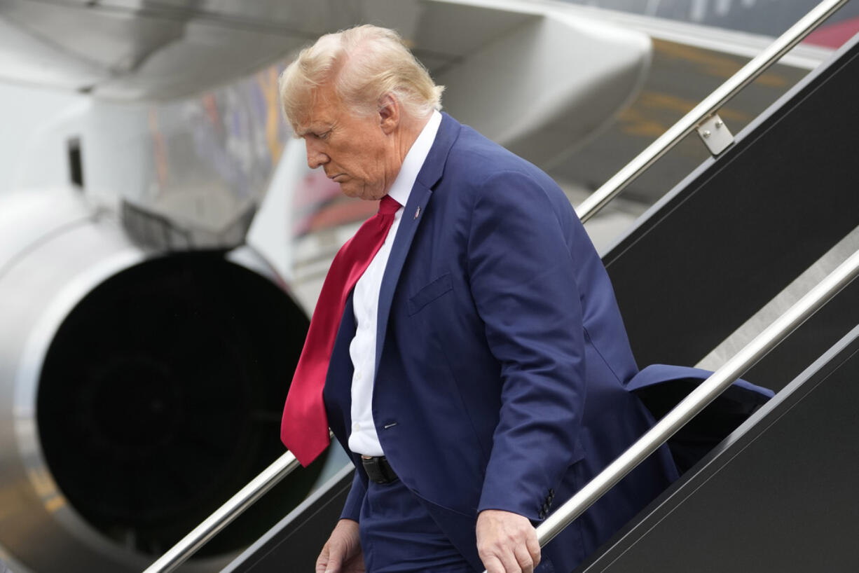 Former President Donald Trump arrives at Ronald Reagan Washington National Airport, Thursday, Aug. 3, 2023, in Arlington, Va., as he heads to Washington to face a judge on federal conspiracy charges alleging Trump conspired to subvert the 2020 election.