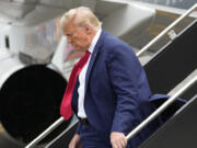 Former President Donald Trump arrives at Ronald Reagan Washington National Airport, Thursday, Aug. 3, 2023, in Arlington, Va., as he heads to Washington to face a judge on federal conspiracy charges alleging Trump conspired to subvert the 2020 election.