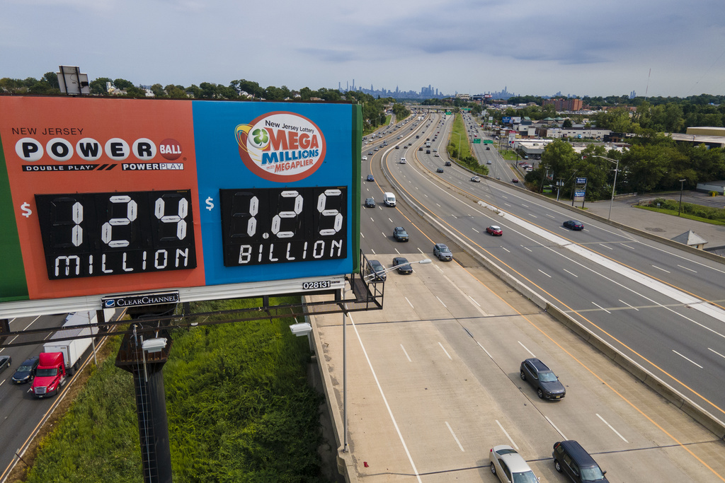 A billboard over Interstate 80 displays a Mega Millions lottery jackpot of $1.25 billion, Thursday, Aug. 3, 2023, in Lodi, N.J. The odds of winning a $1.25 billion Mega Millions jackpot Friday night are infinitesimally small, but that doesn't stop players from some mighty big daydreams of what they would do if they won the giant prize.