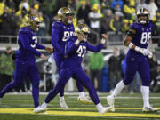 FILE -Washington placekicker Peyton Henry (47) celebrates ith punter Jack McCallister (38), tight end Quentin Moore (88) and long snapper Jaden Green (89) after making a field goal during the second half of an NCAA college football game against Oregon, Saturday, Nov. 12, 2022, in Eugene, Ore. The Big Ten has cleared the way for Oregon and Washington to apply for membership, four people familiar with the negotiations told The Associated Press., Friday, Aug.