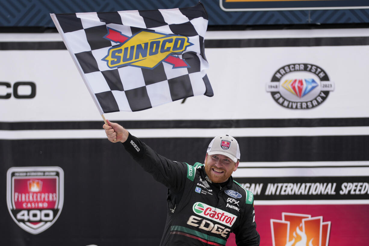 Chris Buescher celebrates his victory during a NASCAR Cup Series auto race at Michigan International Speedway in Brooklyn, Mich., Monday, Aug. 7, 2023.