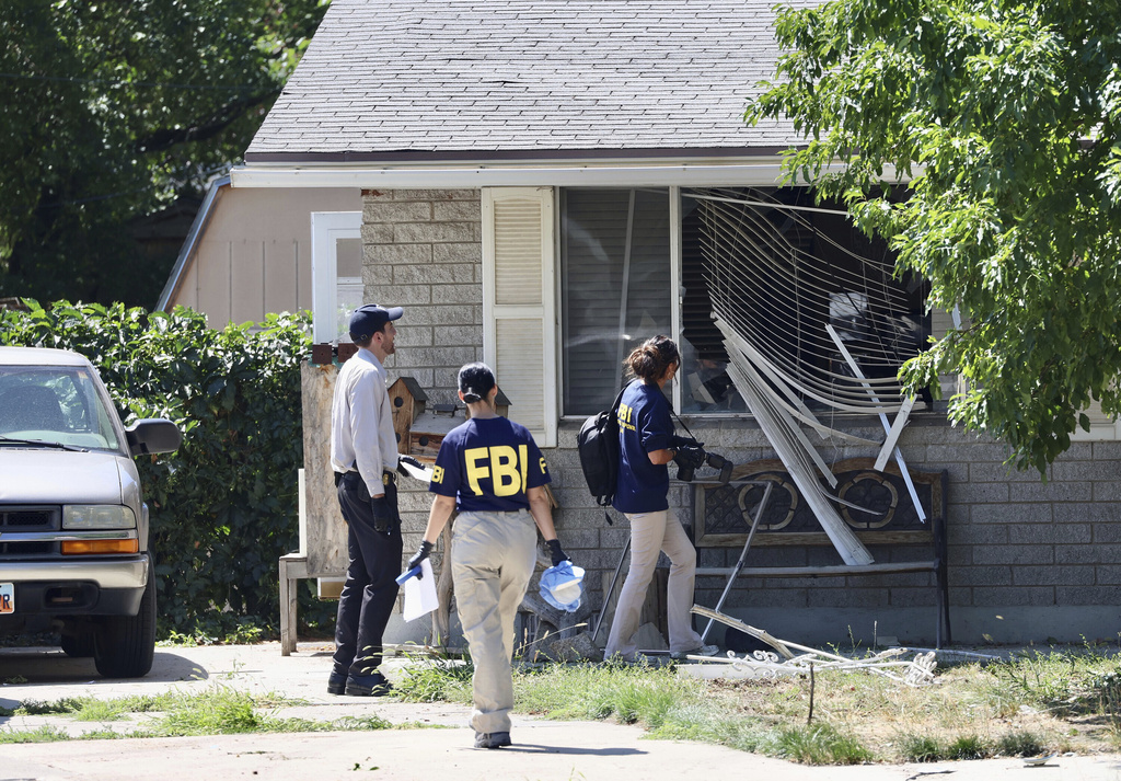 Law enforcement investigate the scene of a shooting involving the FBI Wednesday, Aug. 9, 2023 in Provo, Utah.  A  man accused of making threats against President Joe Biden was shot and killed by FBI agents hours before the president was expected to land in the state Wednesday, authorities said.