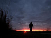 FILE - In this Nov. 20, 2015 file photo, a man walks along a trail during sunset near Manhattan, Kan. In 2022, about 49,500 people took their own lives in the U.S., the highest number ever, according to data from the Centers for Disease Control and Prevention released on Thursday, Aug. 10, 2023.