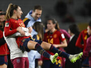 Spain's Olga Carmona is held aloft by a teammate after defeating Sweden in the Women's World Cup semifinal soccer match at Eden Park in Auckland, New Zealand, Tuesday, Aug. 15, 2023.
