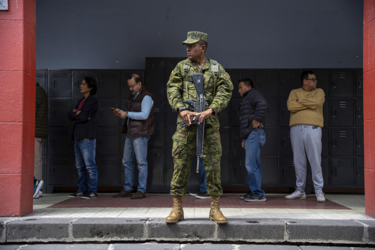 A soldier guards a polling station during a snap presidential election in Quito, Ecuador, Sunday, Aug. 20, 2023.