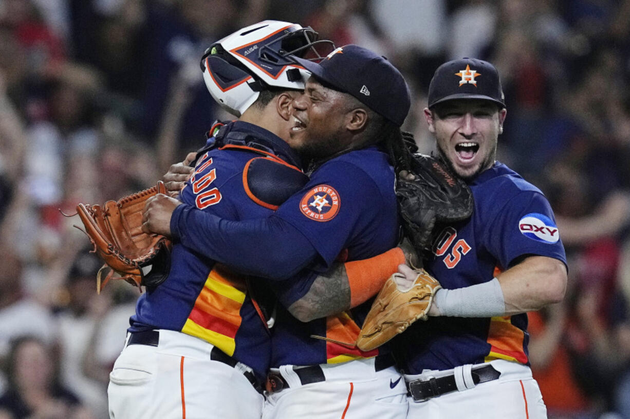 Houston Astros starting pitcher Framber Valdez, center, is embraced by catcher Martin Maldonado and third baseman Alex Bregman after throwing a no-hitter against the Cleveland Guardians, Tuesday, Aug. 1, 2023, in Houston. (AP Photo/Kevin M.