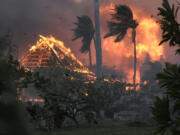 The hall of historic Waiola Church in Lahaina and nearby Lahaina Hongwanji Mission are engulfed in flames along Wainee Street on Tuesday, Aug. 8, 2023, in Lahaina, Hawaii.