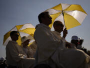 Pilgrims attend a mass presided by the Pope Francis at the Parque Tejo in Lisbon celebrating the 37th World Youth Day on Sunday, Aug. 6, 2023. An estimated 1.5 million young people filled the parque on Saturday for Pope Francis' World Youth Day vigil, braving scorching heat to secure a spot for the evening prayer and to camp out overnight for his final farewell Mass on Sunday morning.