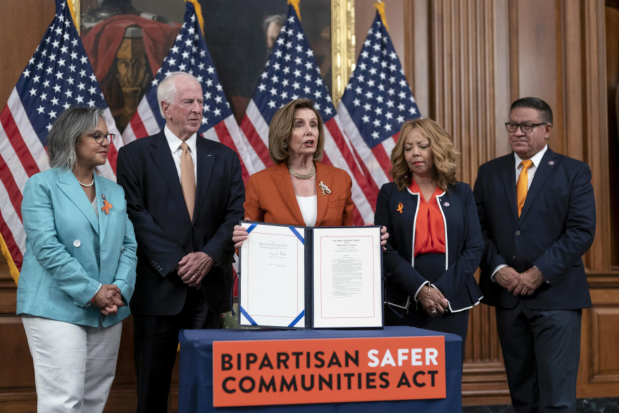 FILE - Speaker of the House Nancy Pelosi, D-Calif., center, is joined by, from left, Rep. Robin Kelly, D-Ill., Rep. Mike Thompson, D-Calif., chairman of the House Gun Violence Prevention Task Force, Rep. Lucy McBath, D-Ga., and Rep. Salud Carbajal, D-Calif., as she enrolls the gun violence safety bill before sending it to President Joe Biden to sign it into law, at the Capitol in Washington, June 24, 2022. (AP Photo/J.