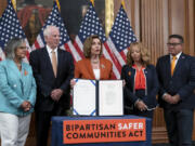 FILE - Speaker of the House Nancy Pelosi, D-Calif., center, is joined by, from left, Rep. Robin Kelly, D-Ill., Rep. Mike Thompson, D-Calif., chairman of the House Gun Violence Prevention Task Force, Rep. Lucy McBath, D-Ga., and Rep. Salud Carbajal, D-Calif., as she enrolls the gun violence safety bill before sending it to President Joe Biden to sign it into law, at the Capitol in Washington, June 24, 2022. (AP Photo/J.