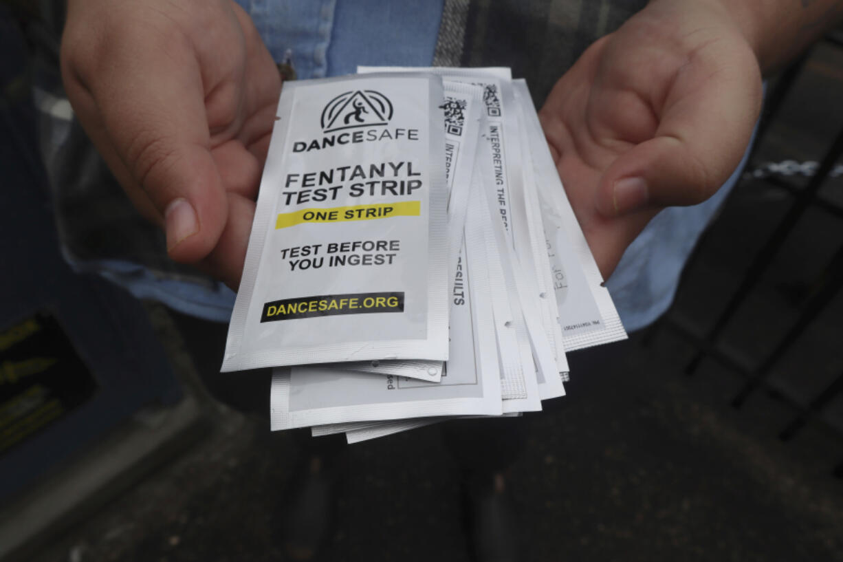 Iris Sidikman, harm reduction coordinator at the Women's Health Center of West Virginia, holds fentanyl testing strips the clinic has on hand to give people dealing with substance use disorder in the clinic parking lot on Thursday, Aug. 4, 2023, in Charleston, W.Va.